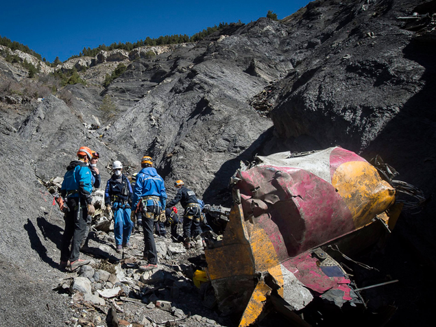 Rescue workers at the scene of the crash (Independent)